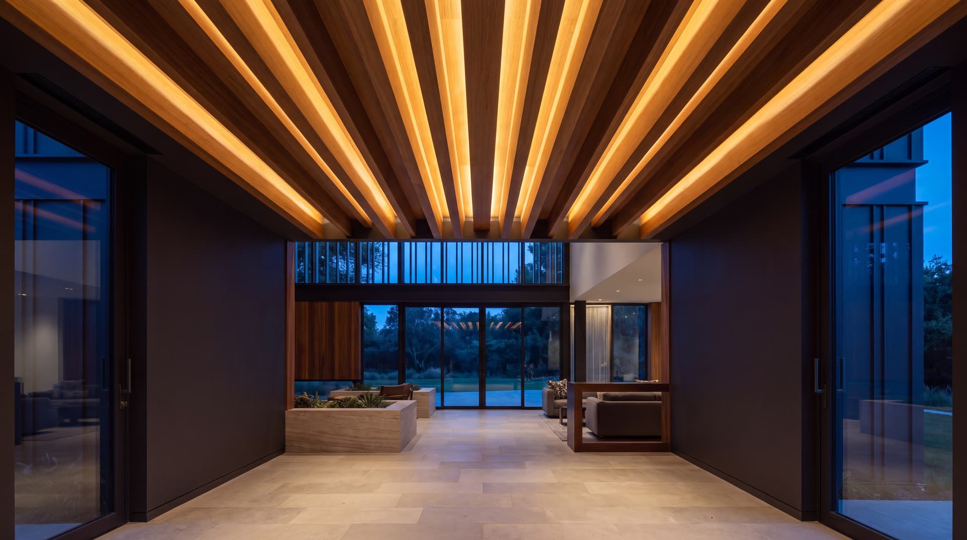 Slatted timber acoustic ceiling over a lit interior corridor