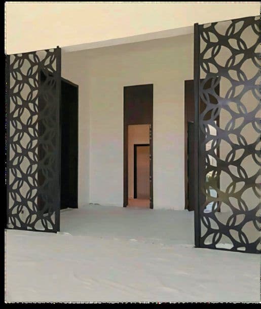 Laser-cut iron mashrabiya gates at the Al Khazami villa
